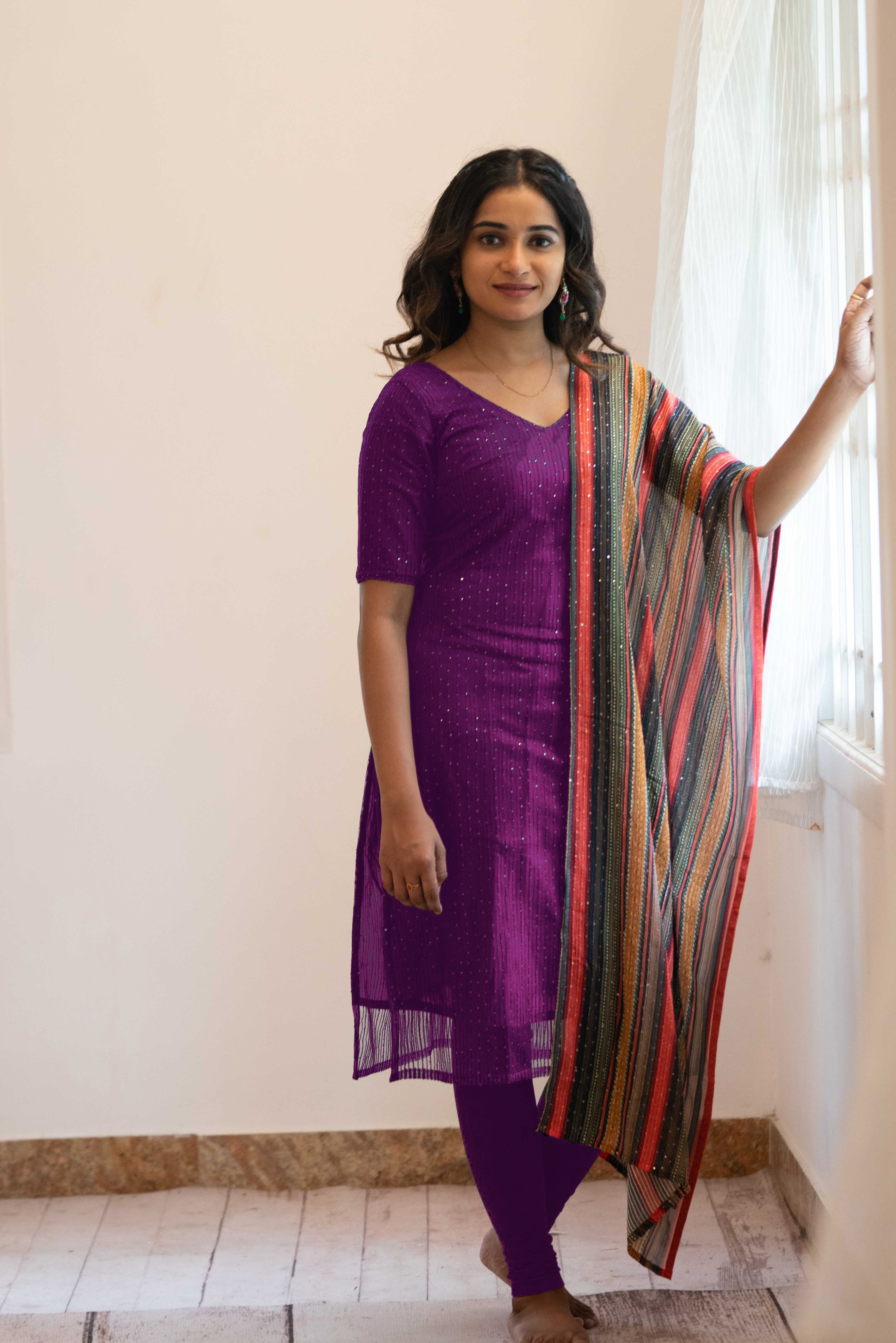 Rust colored viscose Kurti with net sleeves and half body neckline and  collar.